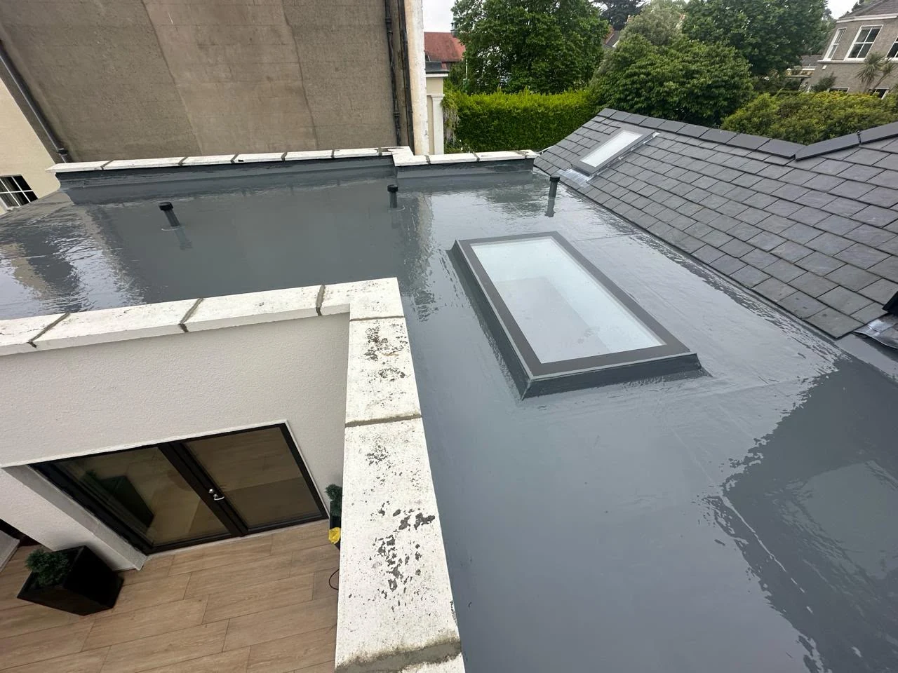 Completed fibreglass roof restoration with rooflight in Dublin by Roof Pro Ltd