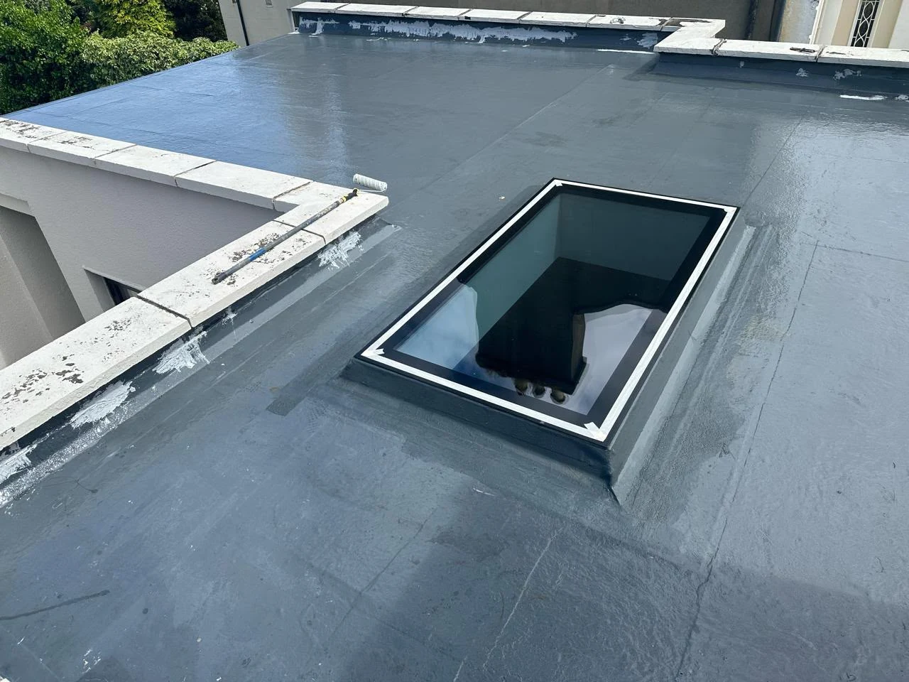 Fibreglass roof restoration finish around a rooflight in Dublin by Roof Pro Ltd
