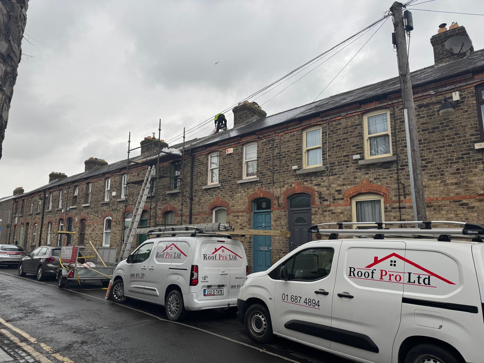 Roof Pro Ltd team carrying out roof repairs on a terraced house in Dalkey Dublin